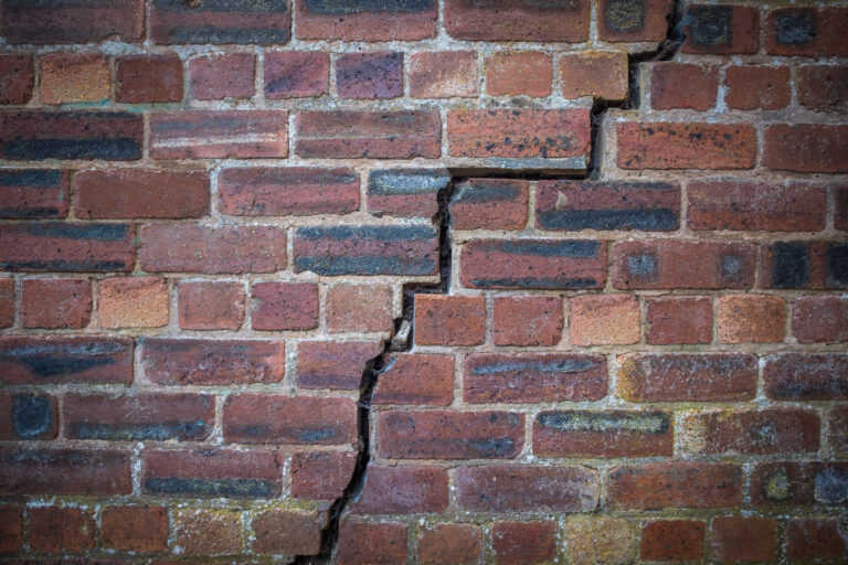 Cracked Red Brick Wall