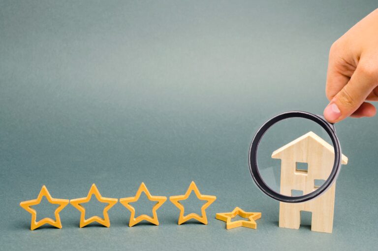 Five stars and a wooden house on a gray background